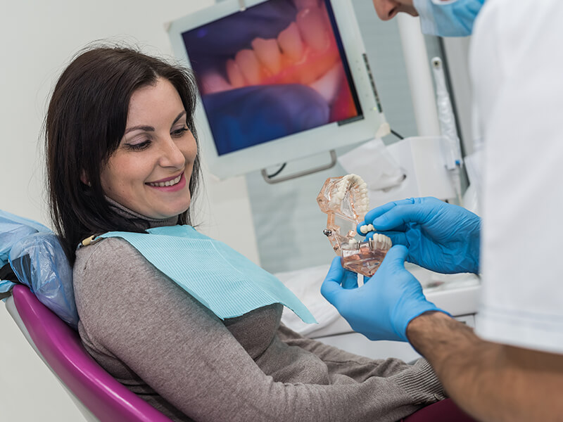 mulher escolhendo sua prótese dentária
